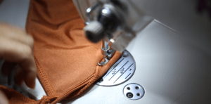 Skilled workers sewing swimwear garments professional production process