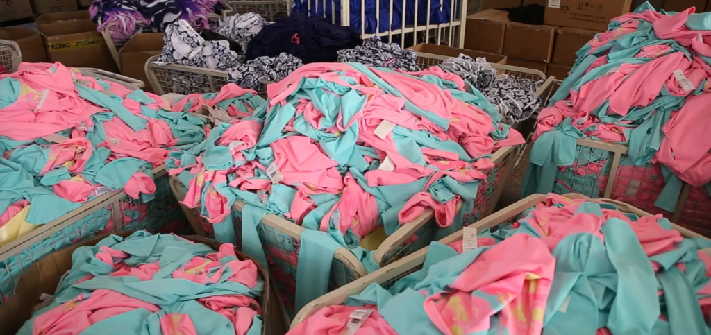 Swimwear fabric warehouse with organized nylon spandex materials