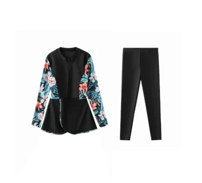 Flat-lay of the full three-piece teal tropical swimwear set: back-zip onesie, solid shorts, and patterned sarong.