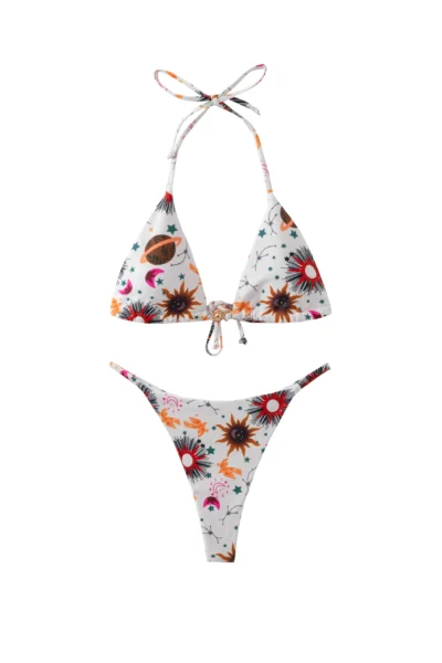 Front flat-lay of a white triangle bikini set with celestial sun, star, and planet print, featuring a gold sun-shaped metal front connector.