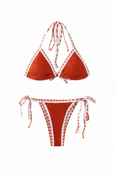 Front flat-lay of a textured orange bikini set with white trim featuring orange zigzag stitching, halter top, and side-tie bottoms.