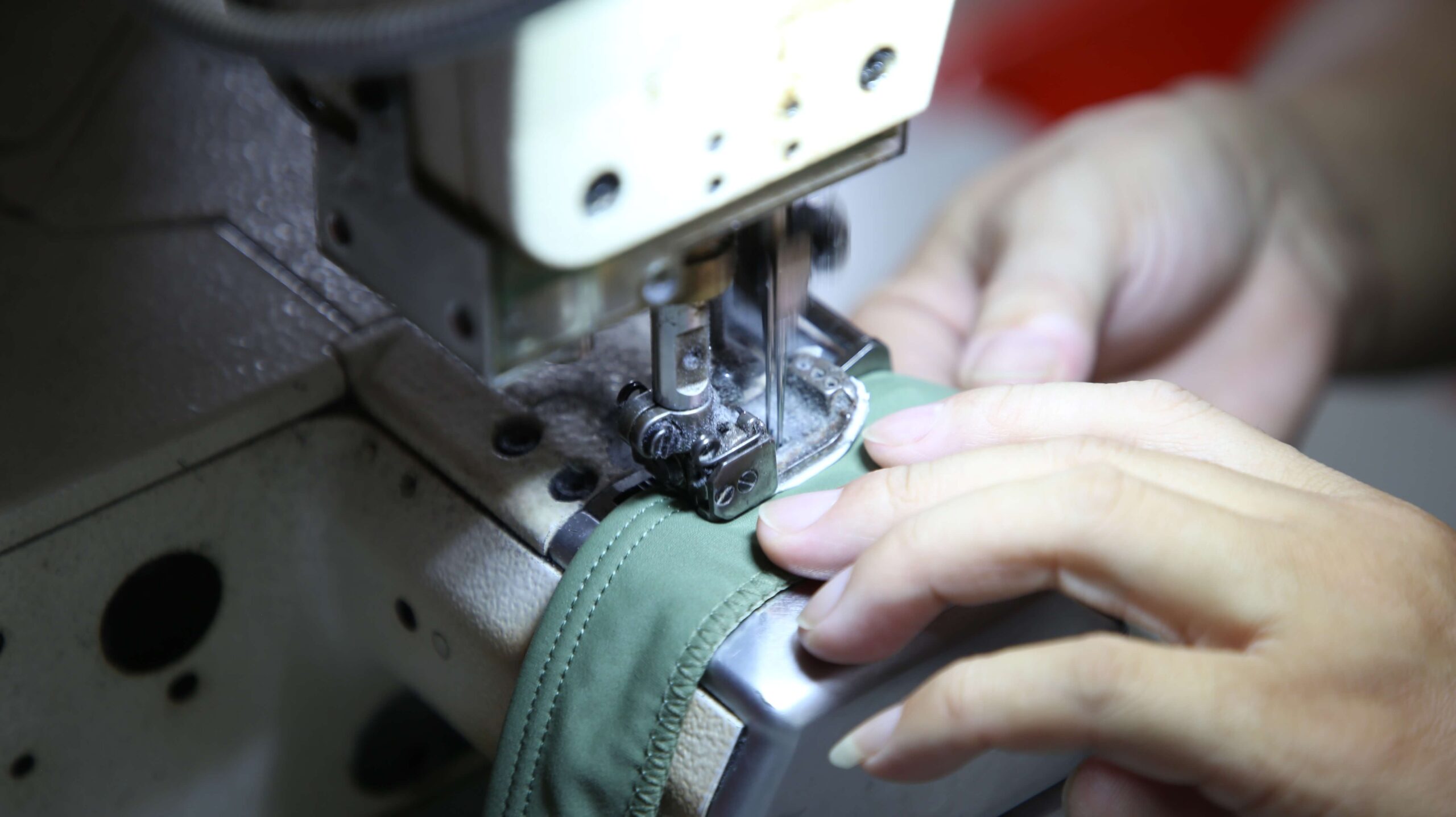 Skilled workers sewing custom swimwear samples in a professional garment factory