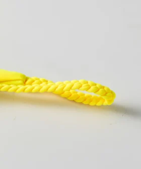 Macro close-up of a yellow braided twist tie strap for a bikini, isolated on a white background.