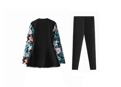 Front flat-lay of solid black full-length swim leggings on a white background.