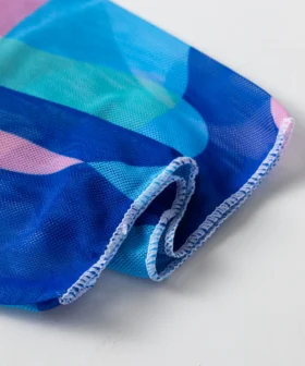 Front flat-lay of the abstract print triangle bikini set, showing the white inner lining of the top and the solid patterned bottom.