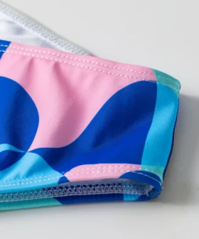 Front flat-lay of the abstract print triangle bikini set with thin neck ties and matching bottoms.