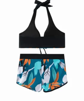 Front flat-lay view of a pale yellow smocked bikini set featuring two blue sequin starfish patches, one on the right top cup and one on the right short leg.