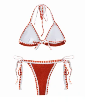Back flat-lay view of the textured orange bikini set featuring white inner lining, halter ties, and side ties.