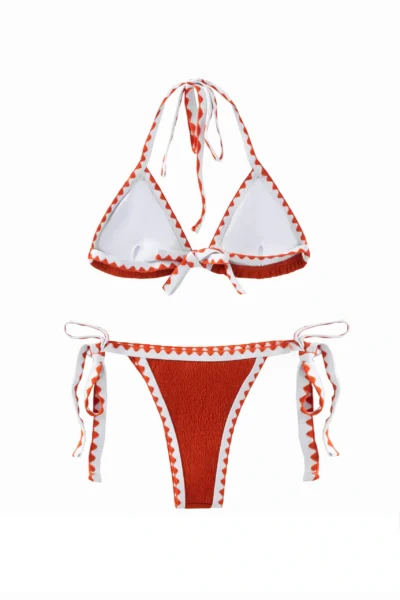 Back flat-lay view of the textured orange bikini set featuring white inner lining, halter ties, and side ties.