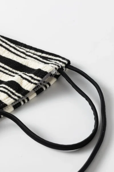 Close-up of black and white striped knitted fabric with a thick, textured finish.
