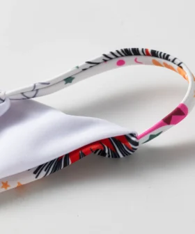 Macro close-up of a printed strap connected to the white inner lining of the bikini top.