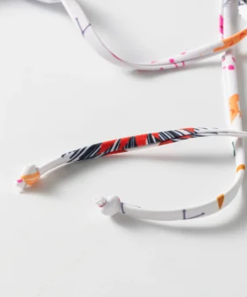 Macro close-up of the knotted ends of the printed bikini tie strings.