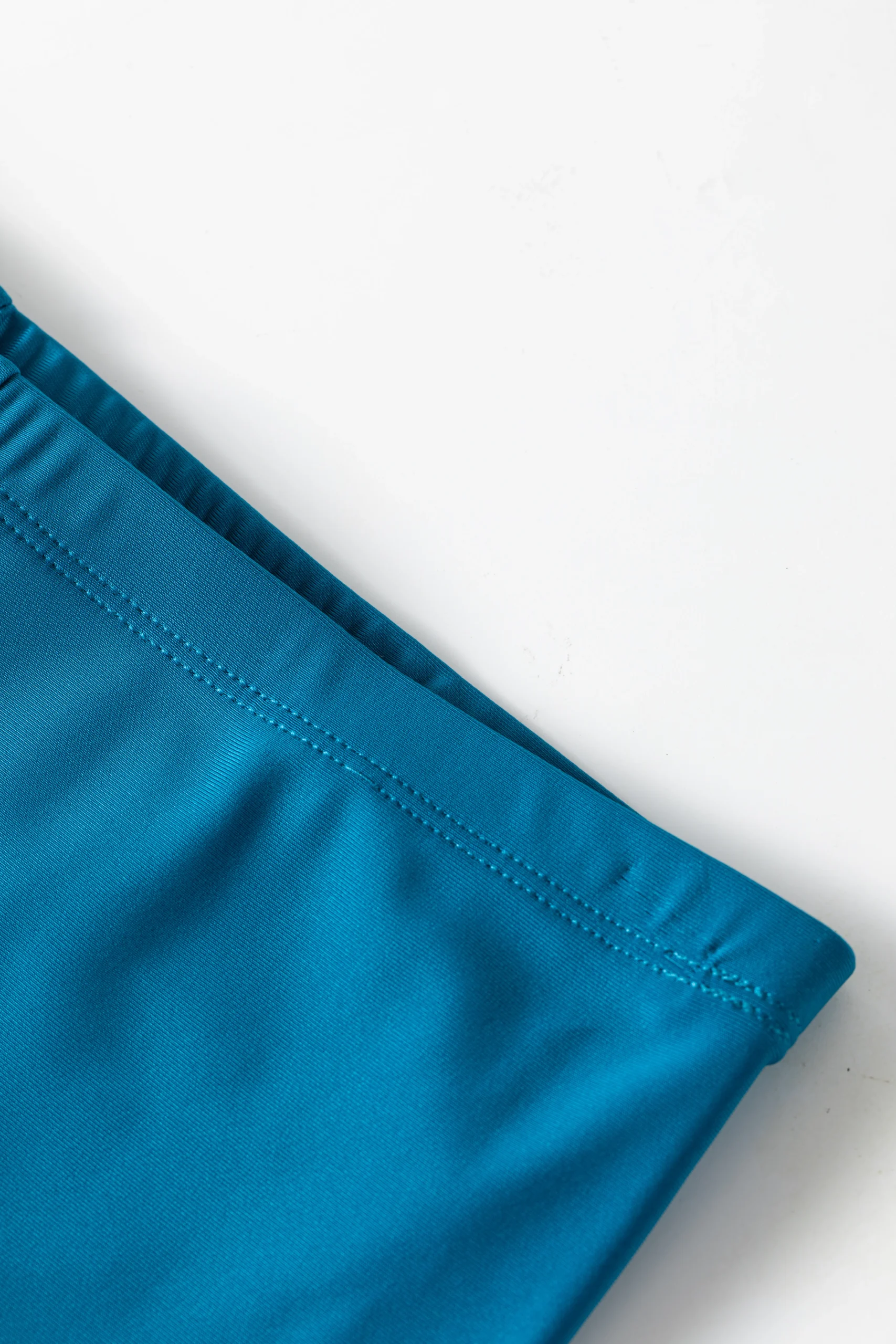 Alternate front view of the teal tropical print sarong skirt, showcasing the side tie knot and fabric drape.