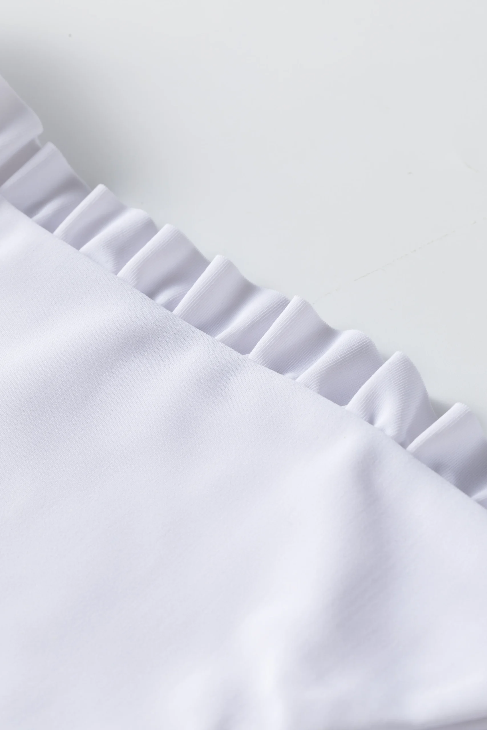 Back flat-lay of solid black full-length swim leggings.