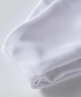 Macro close-up of the black front zipper and round crew neckline on the black swimsuit top.