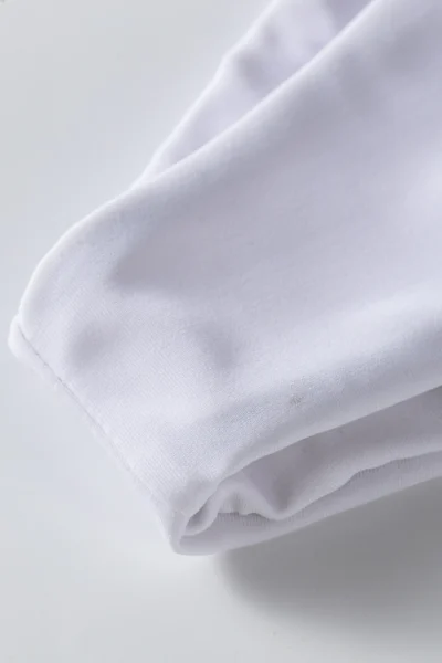 Macro close-up of the black front zipper and round crew neckline on the black swimsuit top.